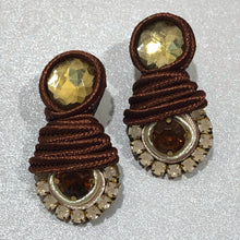 Load image into Gallery viewer, The Ceciel Amy Earrings create an eye-catching look.  Looks great wether you dress it up or just wear it with a simple t-shirt. Earrings made with ​​the intricate soutache technique embroidery. They will come in a gift box.  Handmade with so much love and care using high quality materials. Unique piece. Swarovski crystals and silk tussel. Back is 14K Gold to avoid allergies. Lightweight
