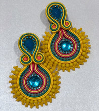 Load image into Gallery viewer, The Ceciel Daisy Earrings create an eye-catching look.  Looks great wether you dress it up or just wear it with a simple t-shirt. Earrings made with ​​the intricate soutache technique embroidery. They will come in a gift box.  Handmade with so much love and care using high quality materials. Unique piece. Swarovski crystals and silk tussel. Back is 14K Gold to avoid allergies. Lightweight
